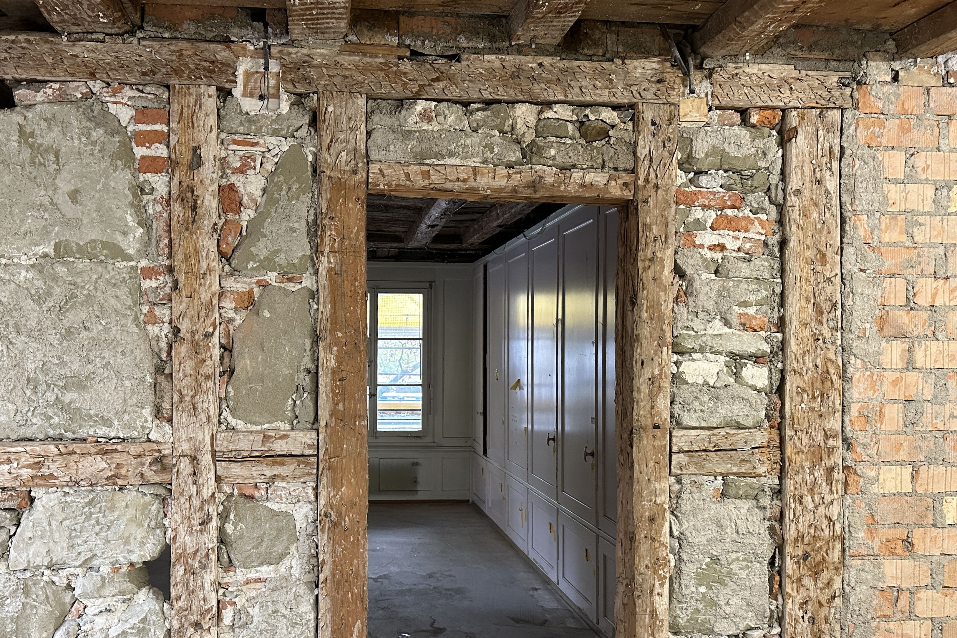 Freigelegte Wand im Erdgeschoss, in Hintergrund Reste eines Täfers aus dem 19. Jahrhundert und Einbauschränke von 1952.